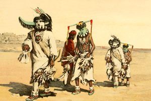 Men dressed in Kachina costumes